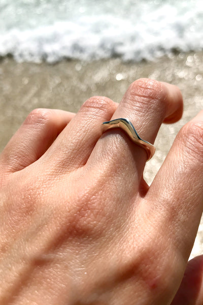 Maresse Wave Ring Sterling Silver Wearing Top View Ocean Background