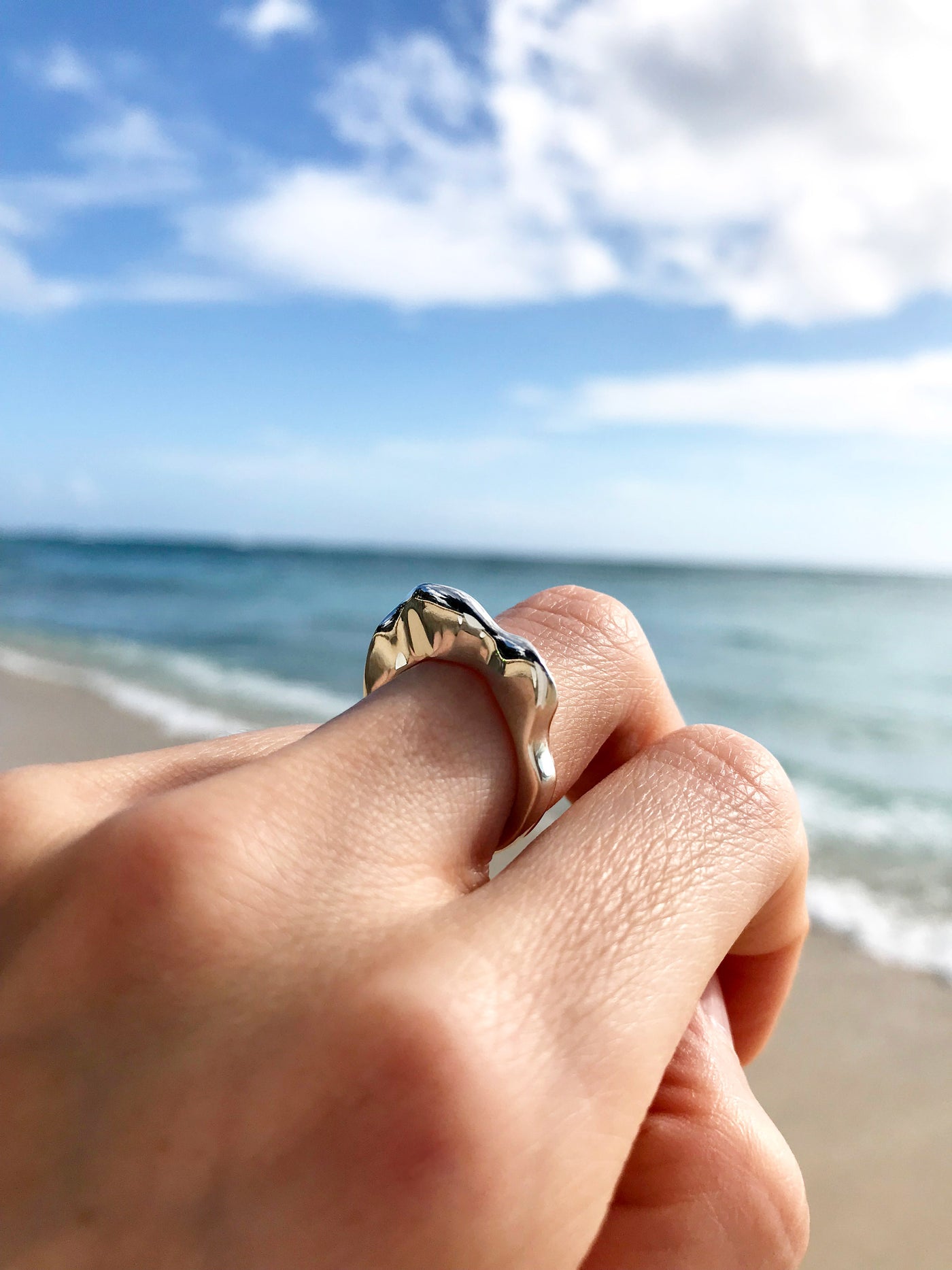 Maresse Splash Ring Sterling Silver wearing ocean background